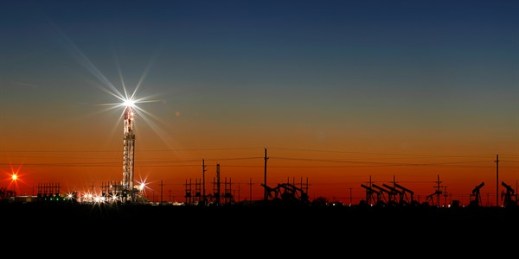 An oil rig lights up the horizon after a late sunset on the outskirts of Midland, Texas, April 2, 2020 (Photo by Eli Hartman for Odessa American via AP Images).