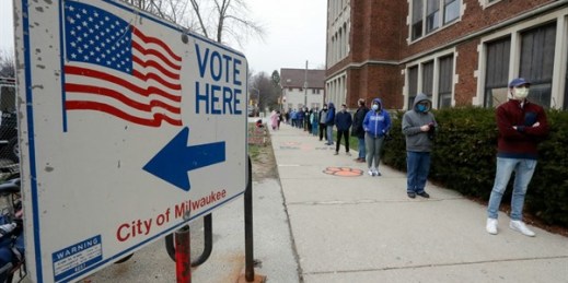 Voters line up to vote in Wisconsin’s primary election, Milwaukee, April 7, 2020 (AP photo by Morry Gash).
