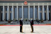 Security officers wearing face masks stand guard outside before the opening session of the Chinese People’s Political Consultative Conference in Beijing, May 21, 2020 (AP photo by Andy Wong).