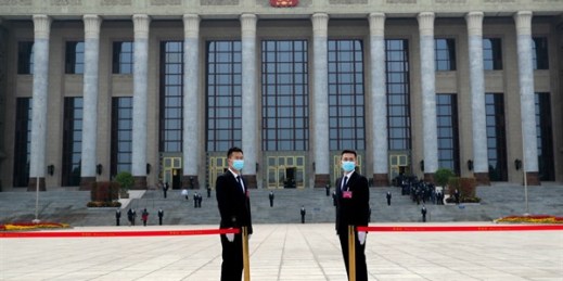 Security officers wearing face masks stand guard outside before the opening session of the Chinese People’s Political Consultative Conference in Beijing, May 21, 2020 (AP photo by Andy Wong).