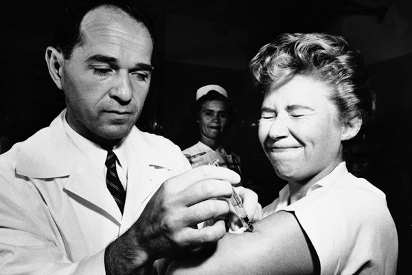 Dr. Joseph Ballinger gives Marjorie Hill, a nurse at Montefiore Hospital in New York, the first vaccine for the H2N2 virus to be administered in New York, Aug. 16, 1957 (AP photo).