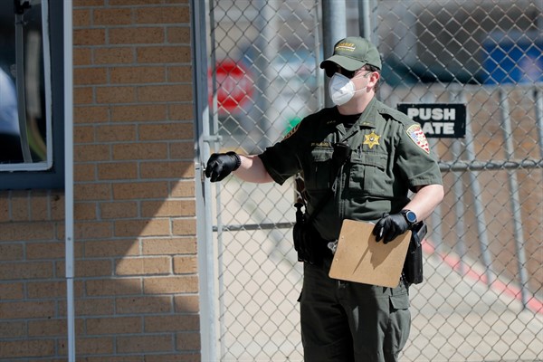 An officer wearing personal protection equipment at the East Baton Rouge Parish jail, Baton Rouge, La., April 21, 2020 (AP photo by Gerald Herbert).