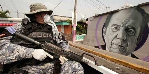 A police special forces officer patrols near a mural of Armando Bukele, father of President Nayib Bukele, in San Salvador, El Salvador, April 23, 2020 (AP photo by Salvador Melendez).