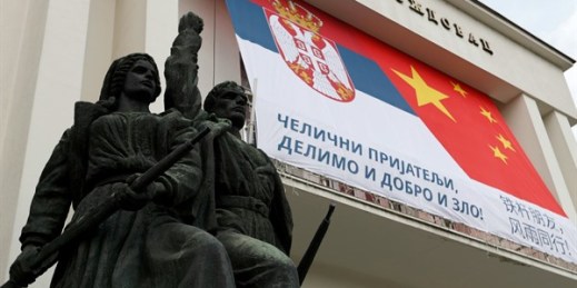 A billboard at a municipal office building showing Serbian and Chinese flags reading: “Iron friends, together in good and evil!” in Belgrade, Serbia, April 13, 2020 (AP photo by Darko Vojinovic).