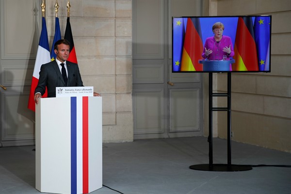 French President Emmanuel Macron listens to German Chancellor Angela Merkel during a joint video press conference at the Elysee Palace, in Paris, May 18, 2020 (AP photo by Francois Mori).