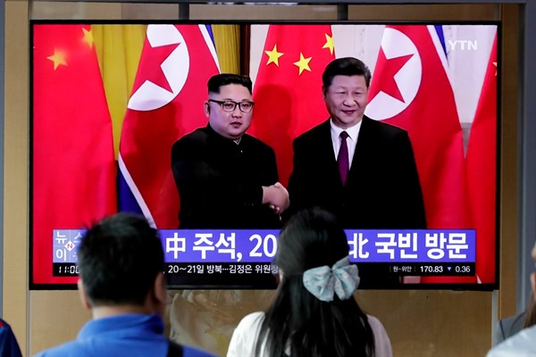 People watch a news program about Chinese President Xi Jinping’s state visit to North Korea at a railway station in Seoul, June 18, 2019 (AP photo by Lee Jin-man).