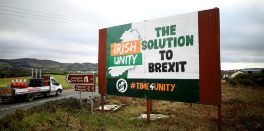 Motorists pass an anti-Brexit poster close to the Irish border, near the town of Newry, Northern Ireland, Feb. 1, 2020 (AP photo by Peter Morrison).