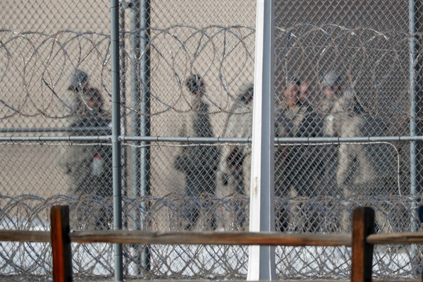 Prisoners stand outside the federal correctional institution in Englewood, Colorado, Feb. 18, 2020 (AP photo by David Zalubowski).