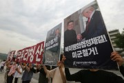 Protesters hold a photo of President Donald Trump and North Korean leader Kim Jong Un at a rally near the U.S. embassy in Seoul, South Korea, June 12, 2020 (AP photo by Ahn Young-joon).
