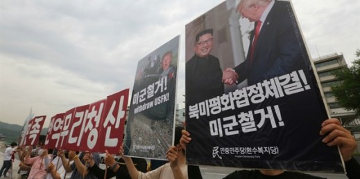 Protesters hold a photo of President Donald Trump and North Korean leader Kim Jong Un at a rally near the U.S. embassy in Seoul, South Korea, June 12, 2020 (AP photo by Ahn Young-joon).