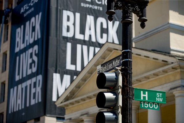 A Black Lives Matter banner hangs from the AFL-CIO building near Black Lives Matter Plaza, close to the White House, Washington, June 12, 2020 (AP photo by Andrew Harnik).