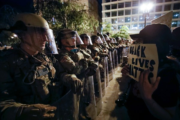 Utah National Guard soldiers face off with demonstrators who had gathered to protest the death of George Floyd, near the White House, Washington, June 3, 2020 (AP photo by Alex Brandon).