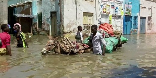 People wade through a flooded street in Beledweyne, central Somalia, May 17, 2020 (AP photo).