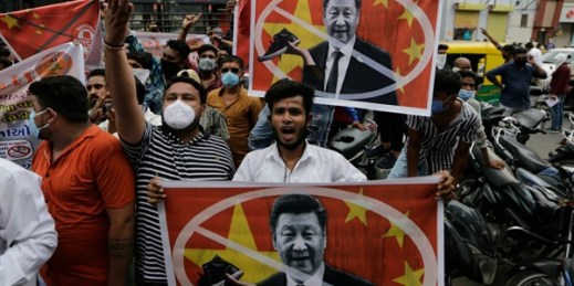 Protesters hold banners with the face of Chinese leader Xi Jinping during a demonstration against China in Ahmedabad, India,  June 24, 2020 (AP photo by Ajit Solanki).
