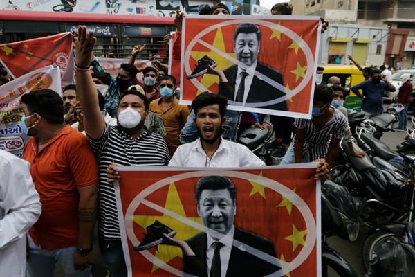 Protesters hold banners with the face of Chinese leader Xi Jinping during a demonstration against China in Ahmedabad, India,  June 24, 2020 (AP photo by Ajit Solanki).
