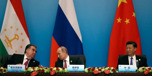 Russian President Vladimir Putin, center, speaks with Tajikistan President Emomali Rahmon, left, next to Chinese leader Xi Jinping right, during a summit in Qingdao, China, June 10, 2018 (AP photo by Dake Kang).