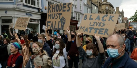 Protesters call for the removal of a statue of Cecil Rhodes, a Victorian imperialist, in Oxford, England, June 9, 2020 (AP photo by Matt Dunham).