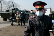 Armed police officers wearing face masks block an area in Almaty, Kazakhstan, March 19, 2020 (AP photo by Vladimir Tretyakov).