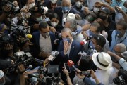 Luis Abinader, the president-elect of the Dominican Republic, is surrounded by journalists at a voting center on Election Day, in Santo Domingo, Dominican Republic, July 5, 2020 (AP photo by Tatiana Fernandez).