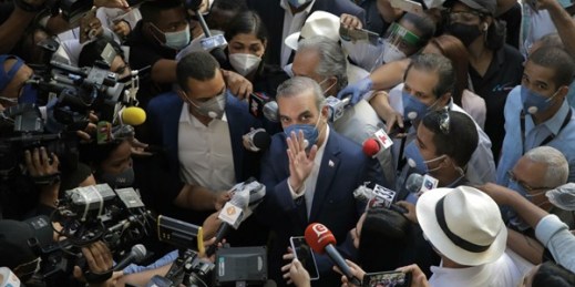Luis Abinader, the president-elect of the Dominican Republic, is surrounded by journalists at a voting center on Election Day, in Santo Domingo, Dominican Republic, July 5, 2020 (AP photo by Tatiana Fernandez).