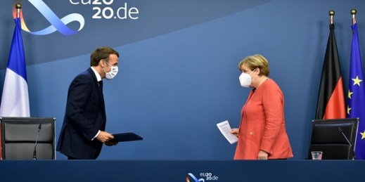 German Chancellor Angela Merkel, right, and French President Emmanuel Macron prepare to address the media at the end of an EU summit in Brussels, July 21, 2020 (AFP pool photo by John Thys via AP Images).