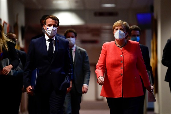 German Chancellor Angela Merkel and French President Emmanuel Macron walk to their press conference room at the end of an EU summit in Brussels, July 21, 2020 (AFP pool photo by John Thys via AP Images).