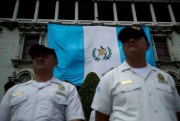 Police stand guard at the National Palace as protestors demonstrate against then-President Jimmy Morales and corruption in Guatemala City, Guatemala, Sept. 20, 2018 (AP photo by Moises Castillo).