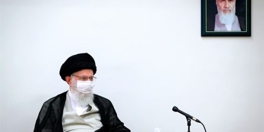Iran’s supreme leader, Ayatollah Ali Khamenei, sits under a portrait of the late revolutionary founder, Ayatollah Khomeini, during a meeting in Tehran, June 31, 2020 (Office of the Iranian Supreme Leader photo via AP Images).