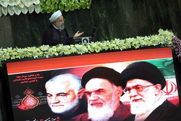 Iranian President Hassan Rouhani speaks behind a screen showing portraits of the late Gen. Qassem Soleimani, the late revolutionary founder Ayatollah Khomeini, and Supreme Leader Ayatollah Ali Khamenei, Tehran, Iran, May, 27, 2020 (AP Photo/Vahid Salemi).