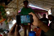 A Rohingya Muslim refugee at a camp in Bangladesh shows a mobile video of a massacre in the village of Gu Dar Pyin in Myanmar, Jan. 14, 2018 (AP photo by Manish Swarup).