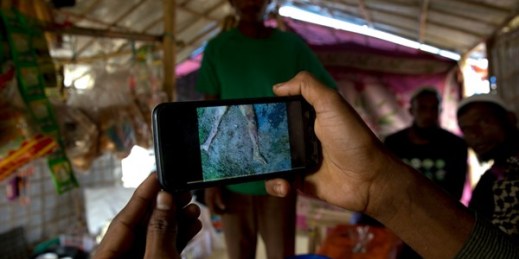 A Rohingya Muslim refugee at a camp in Bangladesh shows a mobile video of a massacre in the village of Gu Dar Pyin in Myanmar, Jan. 14, 2018 (AP photo by Manish Swarup).
