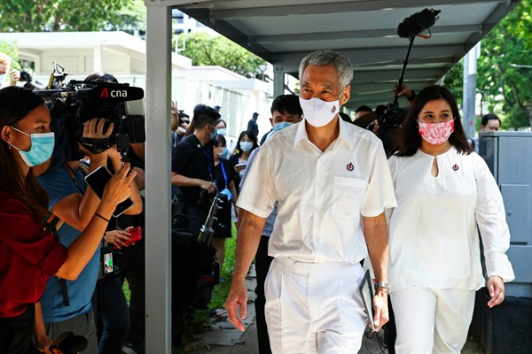 Prime Minister Lee Hsien Loong arrives at a nomination center with his team ahead of the general election in Singapore, June 30, 2020 (AP photo by Yong Teck Lim).