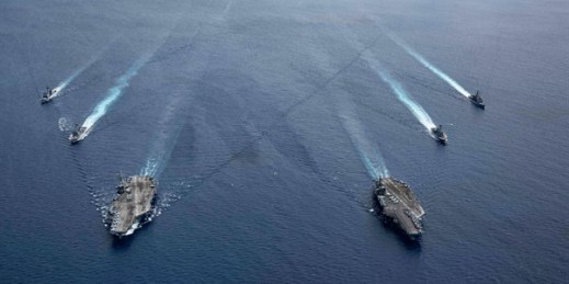 The USS Ronald Reagan and USS Nimitz Carrier Strike Groups steam in formation in the South China Sea, July 6, 2020 (Photo by Mass Communication Specialist 3rd Class Jason Tarleton for U.S. Navy via AP Images).