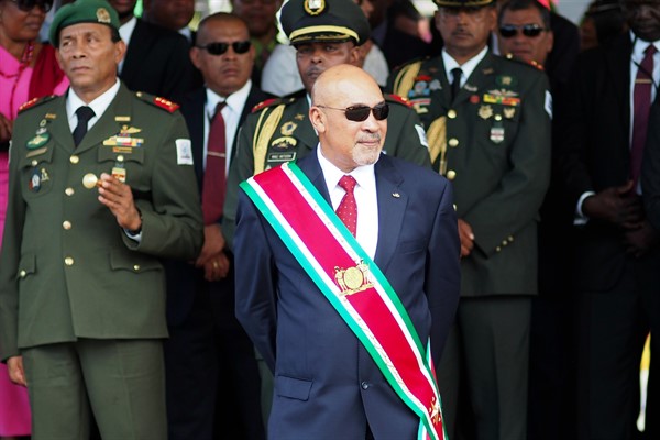 Surinamese President Desi Bouterse observes a military parade after being sworn in for his second term, in Paramaribo, Suriname, Aug. 12, 2015 (AP photo by Ertugrul Kilic).