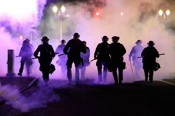 Police officers enveloped by teargas in Portland, Oregon, March 29, 2020 (photo by Dave Killen for The Oregonian via AP Images).
