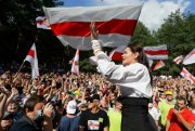 Svetlana Tikhanovskaya, the main opposition candidate for president, greets people waving old Belarus flags at a rally in Brest, Belarus, Aug. 2, 2020 (AP photo by Sergei Grits)