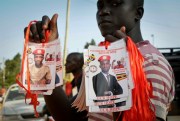 A supporter of Uganda’s opposition holds posters of pop star-turned-lawmaker Bobi Wine, in Kampala, Uganda, Sept. 20, 2018 (AP photo by Ronald Kabuubi).