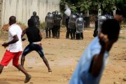 Demonstrators opposed to President Alassane Ouattara running for a third term confront riot police in Abidjan, Cote d’Ivoire, Aug. 13, 2020 (AP photo by Diomande Ble Blonde).