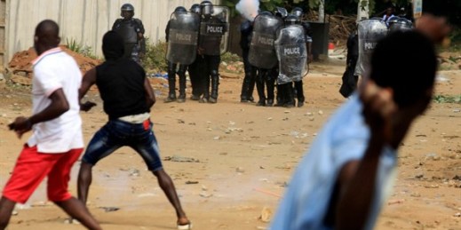 Demonstrators opposed to President Alassane Ouattara running for a third term confront riot police in Abidjan, Cote d’Ivoire, Aug. 13, 2020 (AP photo by Diomande Ble Blonde).