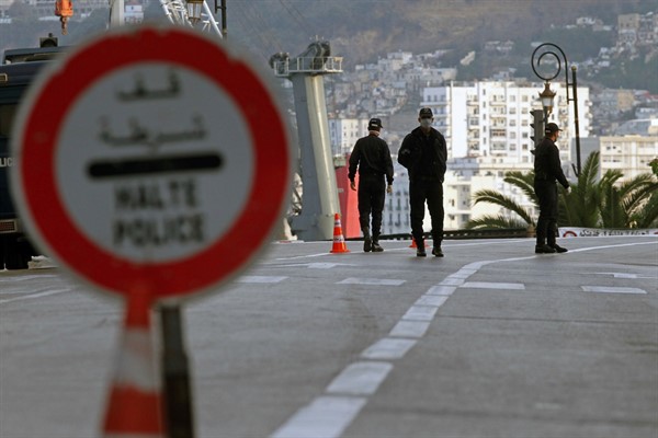 Security forces at a checkpoint to enforce a curfew aimed at preventing the spread of coronavirus in Algiers, Algeria, April 8, 2020 (AP photo by Toufik Doudou).