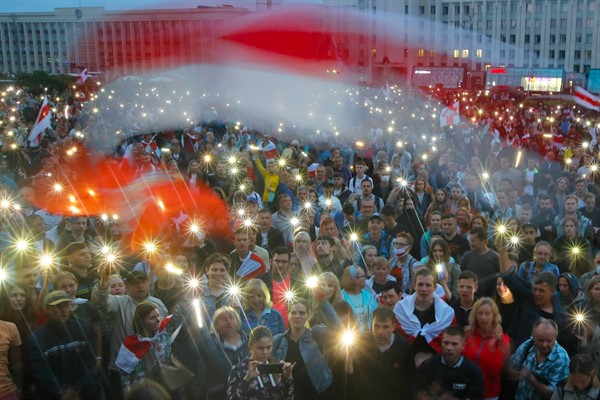 Opposition supporters light phones and wave an old Belarusian national flag during a protest against President Alexander Lukashenko in Minsk, Belarus, Aug. 19, 2020 (AP photo by Dmitri Lovetsky).