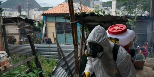 A volunteer sprays disinfectant to help contain the spread of the coronavirus, at the Santa Marta favela in Rio de Janeiro, Brazil, April 10, 2020 (AP photo by Leo Correa).