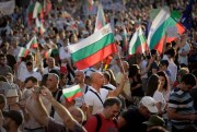 Protesters carry Bulgarian flags during a demonstration in Sofia, Bulgaria, July 29, 2020 (AP photo by Valentina Petrova).