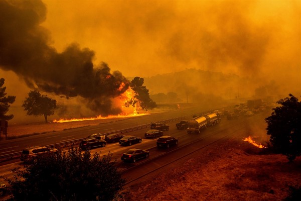 Flames from the LNU Lightning Complex fires jump Interstate 80 in Vacaville, Calif., Aug. 19, 2020 (AP photo by Noah Berger).