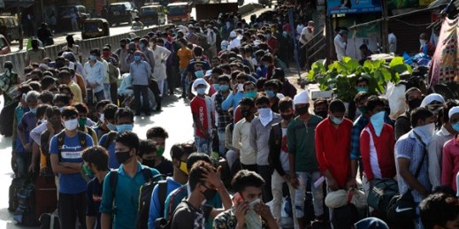 Migrant workers line up for buses to travel back to their home states, at Dharavi, one of Asia’s largest slums, Mumbai, India, May 22, 2020 (AP photo by Rafiq Maqbool).