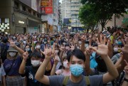 Protesters give a hand signal, signifying the “Five demands, not one less,” during a demonstration against the new national security law in Hong Kong, July 1, 2020 (AP photo by Vincent Yu).