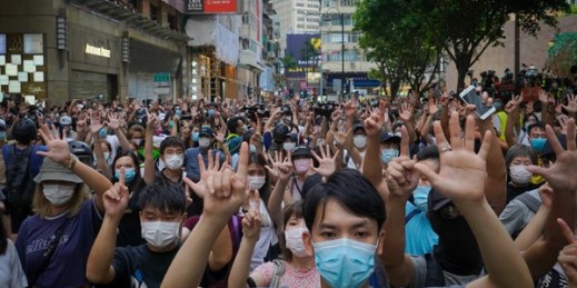 Protesters give a hand signal, signifying the “Five demands, not one less,” during a demonstration against the new national security law in Hong Kong, July 1, 2020 (AP photo by Vincent Yu).