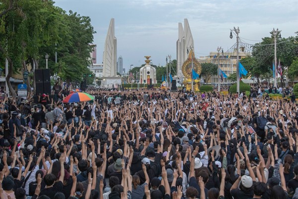 Pro-democracy protesters raise three fingers, a symbol of resistance, during a rally in Bangkok, Thailand, Aug, 16, 2020 (AP photo by Sakchai Lalit).