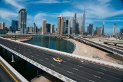 A lone taxi cab drives over a typically gridlocked highway in Dubai, United Arab Emirates, April 6, 2020 (AP photo by Jon Gambrell).