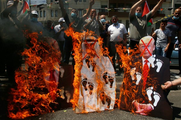 Palestinians burn pictures of U.S. President Donald Trump, Abu Dhabi Crown Prince Mohammed bin Zayed and Israeli Prime Minister Benjamin Netanyahu during a protest in Nablus, West Bank, Aug. 14, 2020 (AP photo by Majdi Mohammed).